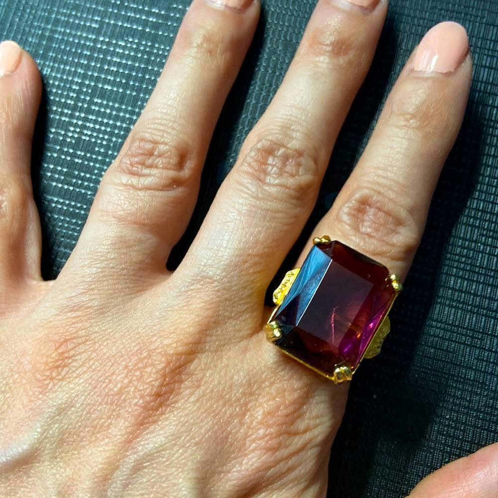 Beautiful adjustable cocktail ring.  Rich plated finish.  Stone is purple.